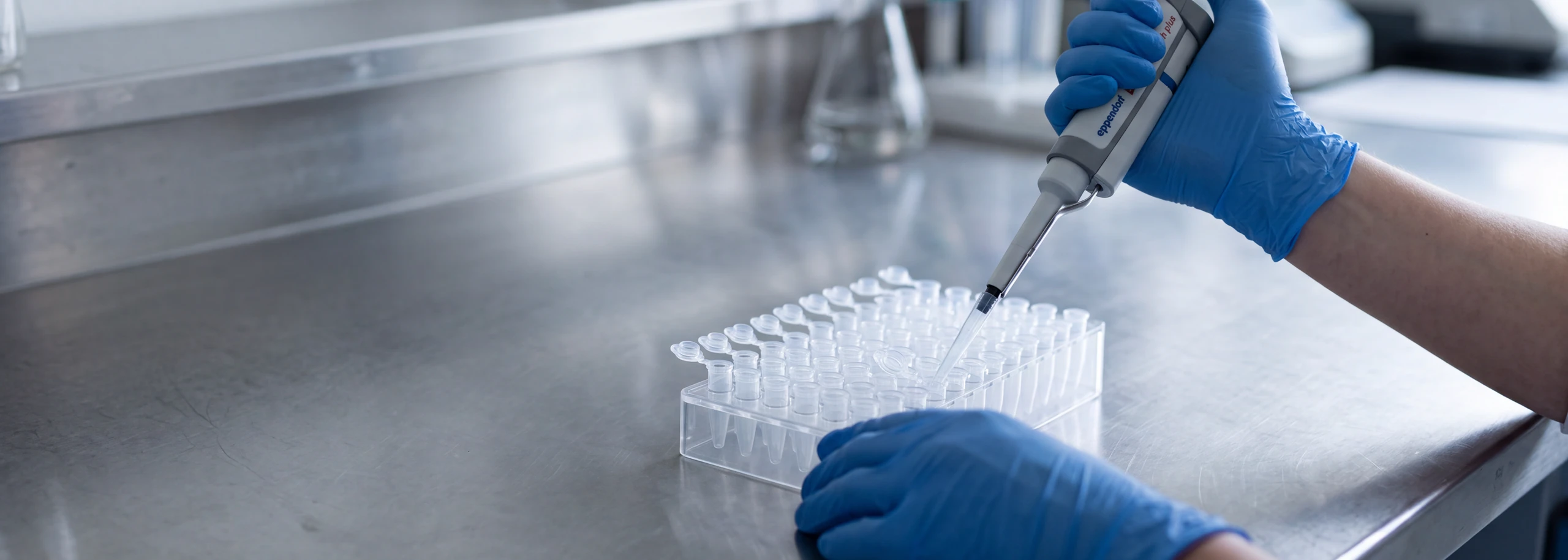Bench — gloved hands, pipette, cold surface